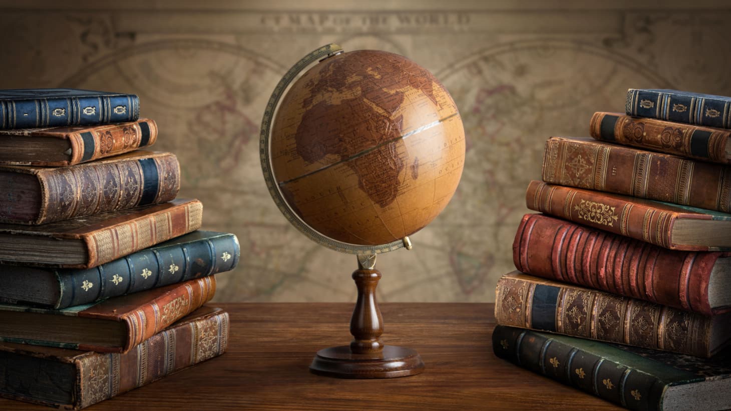 Photograph of a globe sitting on a desk surrounded by books // Photograph from collegetransitions.com